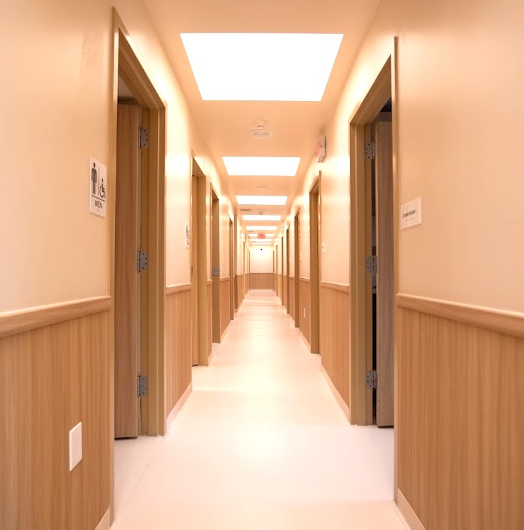 Bright medical office hallway with exam room doors inside Altheda Medical Center near Pittsburgh