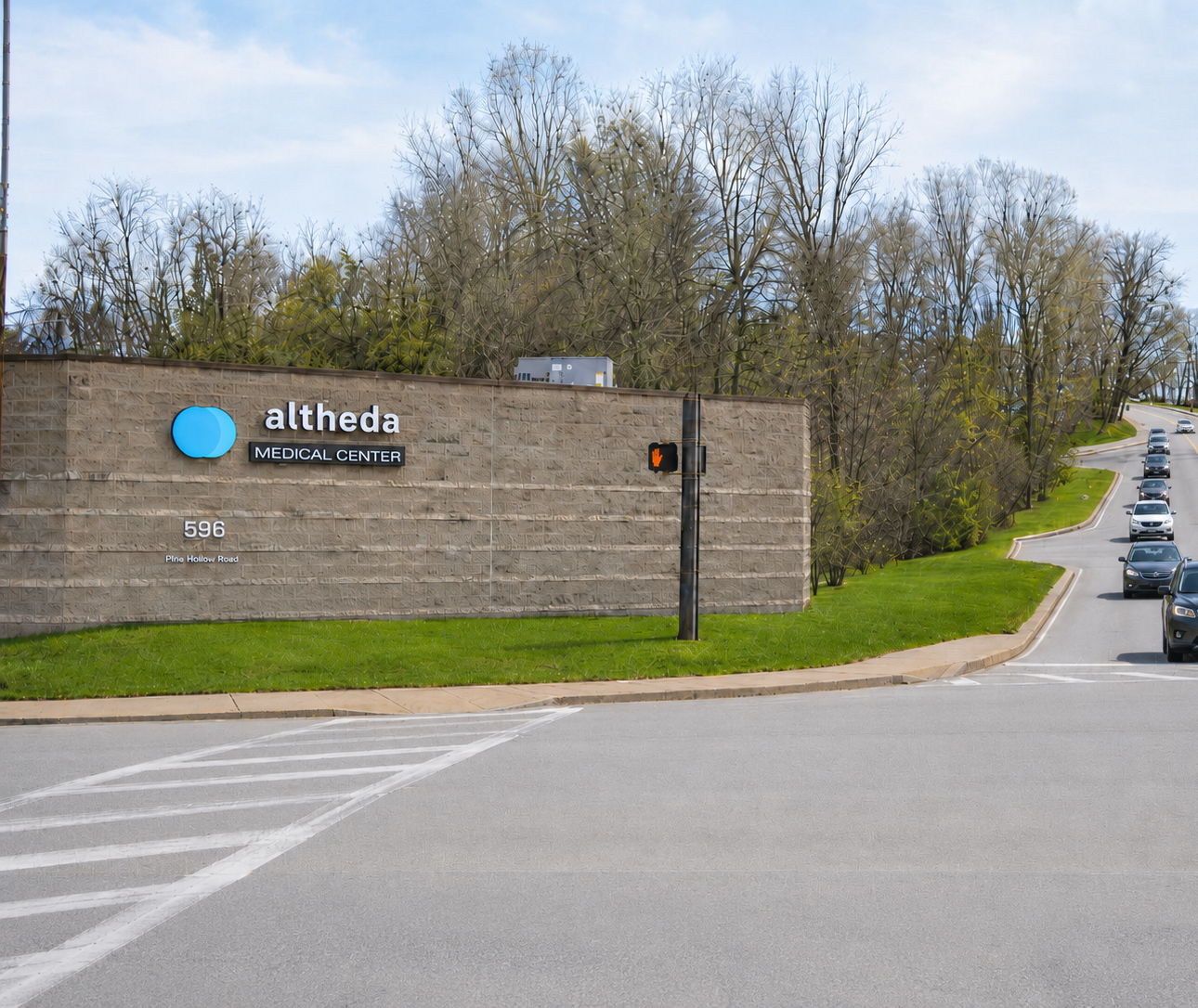 Exterior view of Altheda Medical Center at 596 Pine Hollow Road in Kennedy Township, with vehicles traveling along the nearby road.