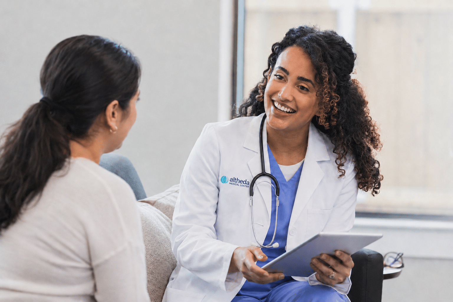 Clinical image for Altheda Medical Center's medical weight management page in Pittsburgh showing provider having respectful weight-management conversation with adult patient.